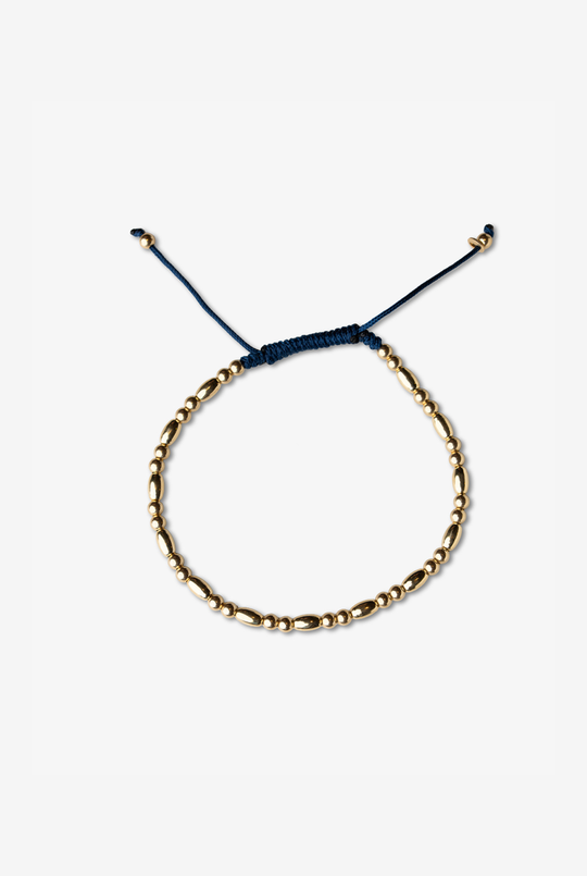 Pulseira em ouro amarelo com algodão azul