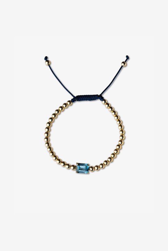 Pulseira em ouro amarelo com topázio azul.