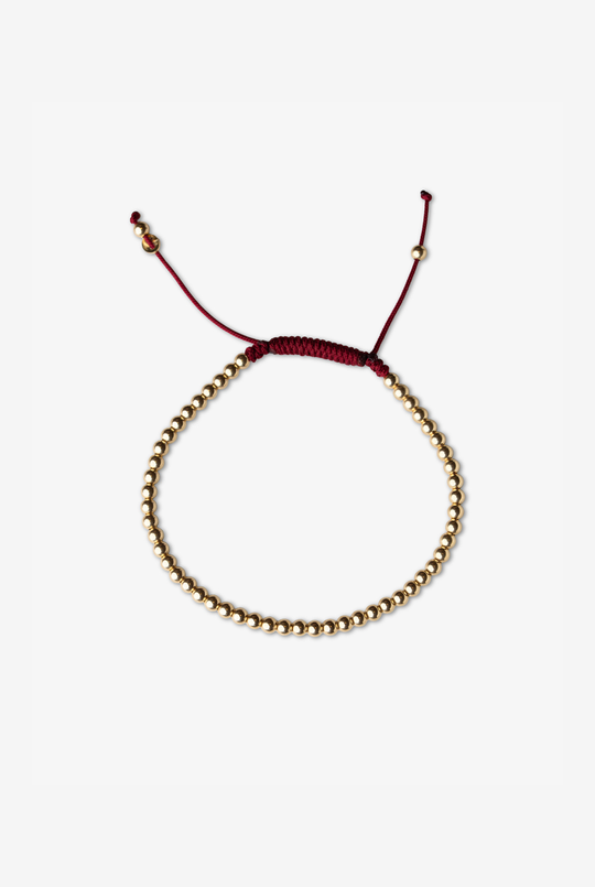 Pulseira às bolinhas em ouro amarelo com algodão bordeaux