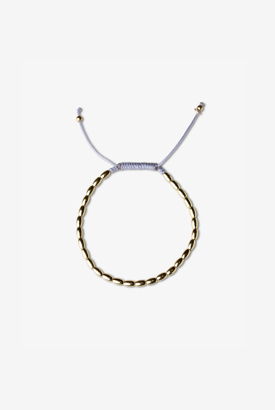 Pulseira em ouro amarelo com algodão lilás